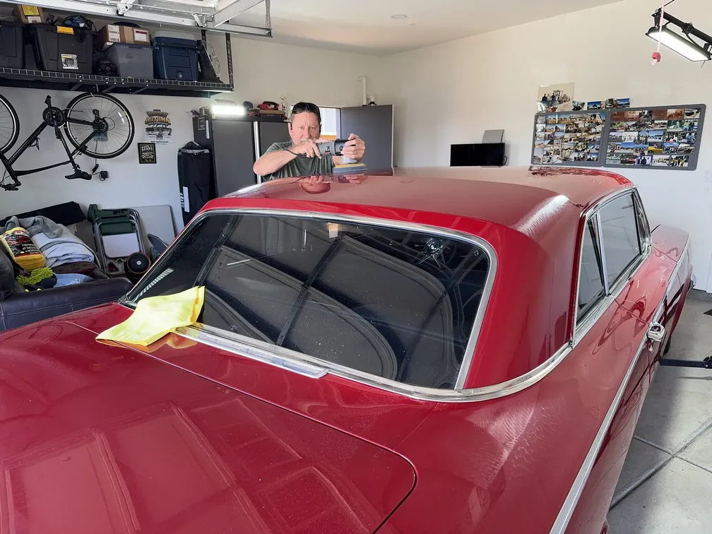 1962 Chevrolet Impala Red Rosso for annual maintenance - Sean Woodward working hard polishing roof.